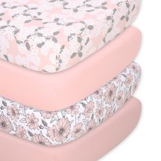 three mattresses stacked on top of each other with pink and white floral print covers