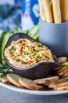 a white plate topped with crackers and dip