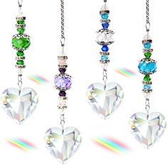 four necklaces with different colored stones hanging from chains on a white background in the shape of hearts