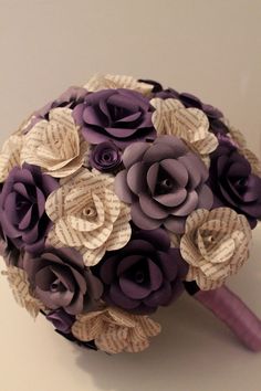 a bridal bouquet made out of purple paper flowers