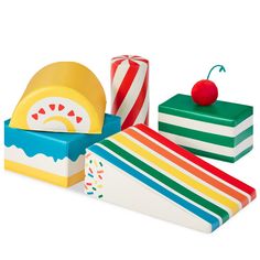 three colorful boxes with different designs on them and one has a red apple in the middle