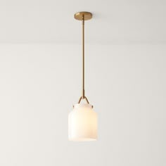 a light fixture hanging from the ceiling in a room with white walls and flooring