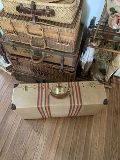 three suitcases stacked on top of each other in a room with wood floors and walls