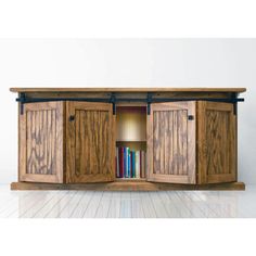 a book shelf with two doors open to reveal books