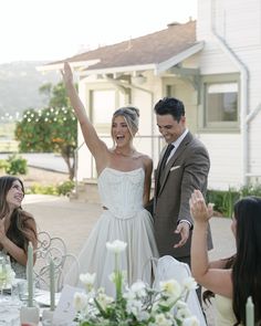 a bride and groom are celebrating at their wedding reception