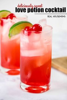 two glasses filled with red liquid and garnished with cherries