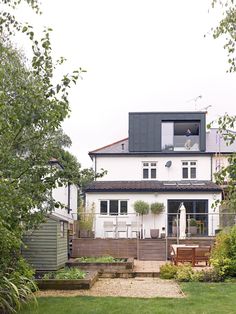 a large white house sitting on top of a lush green field