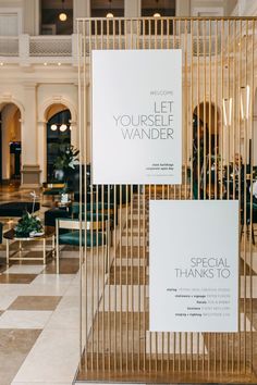 two signs on display in the lobby of a hotel