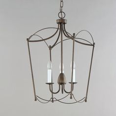 a chandelier with three candles hanging from it