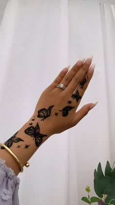 a woman's hand with tattoos on it