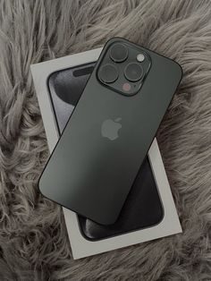 an iphone 11 pro in its box on top of a furnishing area next to it's packaging