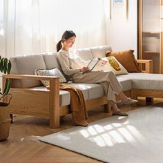 a woman sitting on a couch reading a book