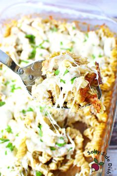 a casserole dish filled with pasta and chicken, topped with parmesan cheese