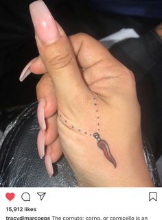 a woman's hand with a small tattoo on it