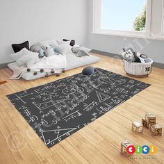 a blackboard rug in the middle of a room with pillows and toys on the floor