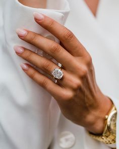 a close up of a person's hand with a ring on it