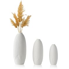 three white vases with yellow flowers in them