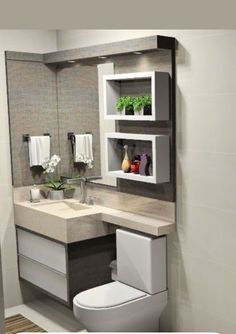 a white toilet sitting next to a sink in a bathroom under a mirror above it