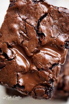 two brownies with chocolate frosting stacked on top of each other