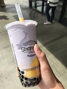 a person holding up a bubble tea in their hand