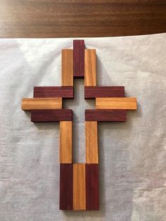 a wooden cross sitting on top of a piece of paper