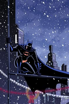 batman on the roof of a building with snow falling all over it and buildings in the background