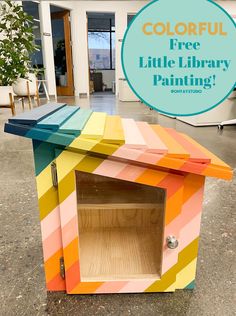 a little library painted with colorful stripes and the words, colorful free little library painting