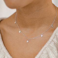 This delicate chain necklace is made from 18 karat gold-plated sterling silver and features five tiny charms attached to its front edge, each one made from four round zirconia arranged like a small flower. It closes at the center back with a spring clasp along with an extension chain, making the overall length adjustable. Stylish and feminine, this piece will suit small prints, flowy blouses and tiered summer dresses. 🎁 Packaging: Beautifully packed in a box, ready for gifting. Details: ✅ Material: 925 sterling silver with 18K gold plated or 18K rose gold plated, cubic zirconia ✅ Length: 41.0 cm (16.14 inches) + 5.0 cm (1.96 inches) extension ✅ Charm size: 5.9 mm (0.23 inches) ✅ Available in gold and rose gold 🏷️ This product is made of sterling silver -- easily recognizable by its '925' Dainty Silver Necklace, Dainty Silver Jewelry, Dainty Jewelry Silver, Silver Neckalce, Delicate Silver Necklace, Tiny Charm, Flower Pendant Necklace, Elegant Necklaces, Dainty Jewelry