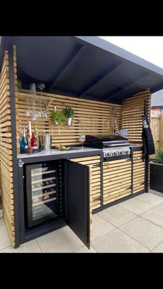 an outdoor kitchen made out of wooden slats