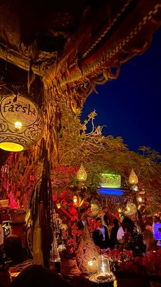 an outdoor restaurant with lights and decorations at night