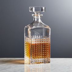 a glass decanter with some liquid in it