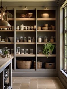 a kitchen filled with lots of open shelves