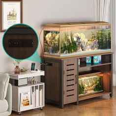 a fish tank sitting on top of a wooden cabinet next to a white couch and table