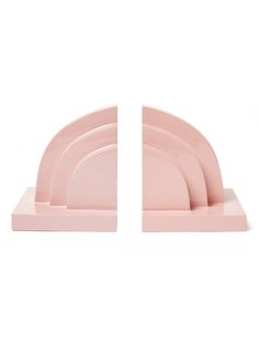 two pink plates sitting side by side on top of each other in front of a white background