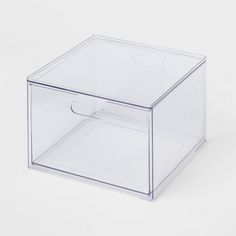 a clear plastic box with a handle on the bottom and two drawers below it, sitting on a white surface