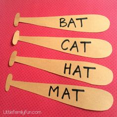 three wooden spoons with the words bat cat hat mat written in black on them