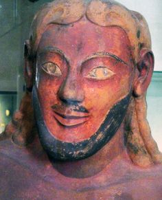 an ancient statue is displayed in a museum