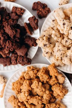 three plates filled with different types of cookies and treats on top of white paper plates