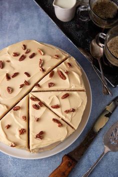 a cake with slices cut out on a plate next to spoons and measuring cups