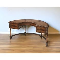 an antique desk with two drawers on the top and one drawer at the bottom, sitting on a hard wood floor