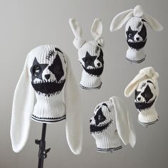 four knitted bunny hats on a mannequin's head, all in black and white