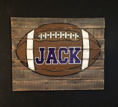 a wooden pallet with a football painted on it's side and the word jack written