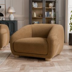 a living room with two chairs and a book shelf