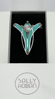 "This very stylish and fine quality antique Art Nouveau brooch is made from silver with guilloche enamel in a pale blue to turquoise colour. I think that the photos in the listing give a good indication of the actual colour of the enamel. The top of the brooch is inset with a freshwater pearl panel and the very top and edges of the brooch are inset with small pearlescent coloured stones. It measures 1.75\" inches high by just under 1.75\" inches wide. It is in excellent condition, please see all Luxury Silver Art Nouveau Brooch, Elegant Turquoise Brooches For Collectors, Turquoise Cabochon Brooch As A Gift, Turquoise Cabochon Brooch For Gift, Art Deco Blue Brooches As Gifts, Art Deco Blue Brooches For Gifts, Formal Silver Enamel Brooches, Art Deco Jewelry 1920s, Antique Turquoise Jewelry