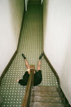 a woman is laying down on the stairs