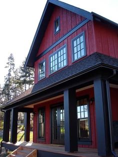 a red house with black trim and windows