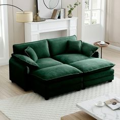 a green couch sitting on top of a hard wood floor