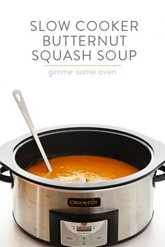 a slow cooker with a spoon in it and the words slow cooker butternut squash soup