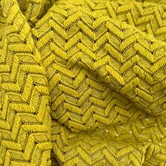 a close up view of a yellow knitted blanket