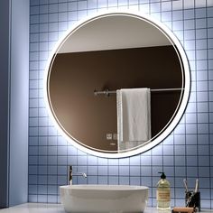 a bathroom with a sink, mirror and soap dispenser on the counter